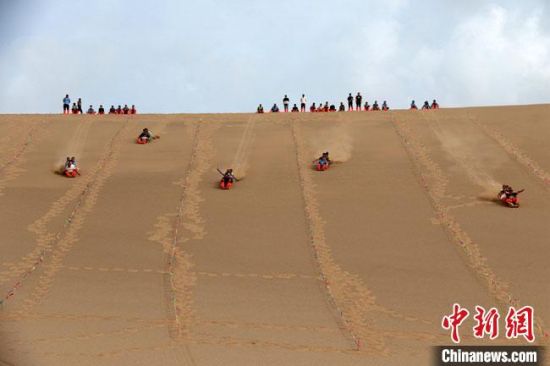 6月13日，敦煌鳴沙山月牙泉景區(qū)舉辦滑沙比賽?！垥粤?攝
